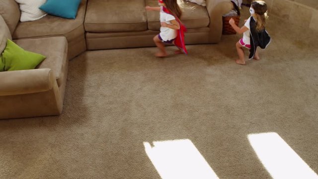 Young girls dressed as superheroes playing at home - 4K