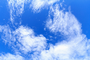 Blue sky background with white clouds. The vast blue sky and clouds sky on sunny day. White fluffy clouds in the blue sky.