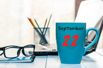 September 22nd. Day 22 of month, calendar on blue coffee cup at Programmer Analyst workplace...