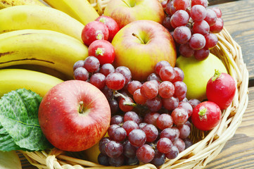 Naklejka na ściany i meble The fruits are eaten throughout the year and useful. A variety of fruit in a basket