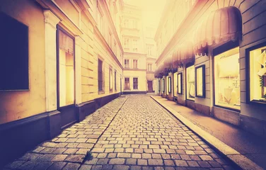 Fotobehang Vintage toned picture of a narrow street in Vienna, old film effect, Austria. © MaciejBledowski