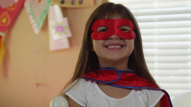 Young girls dressed as superheroes playing at home - 4K