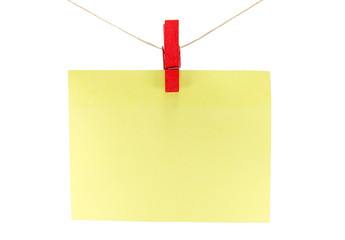 yellow sheet of paper for notes and paperclip