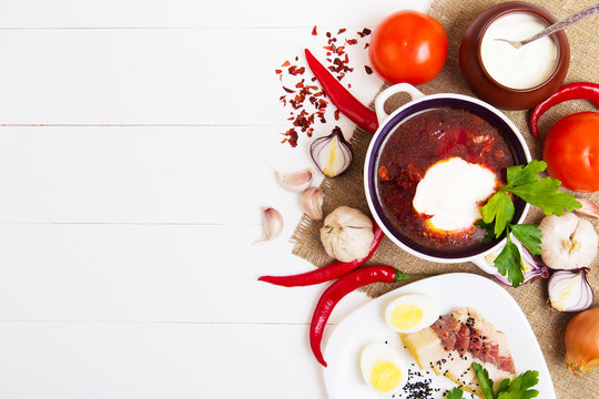 Ukrainian beetroot soup - borscht, on wooden background with ingredients