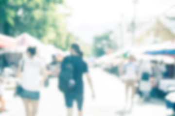 Blurred image of people shopping at street market use for backgr