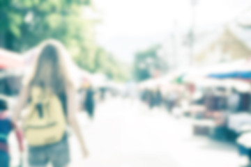 Blurred image of people shopping at street market use for backgr