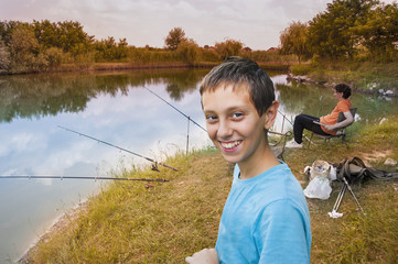 Father and sons fishing on river