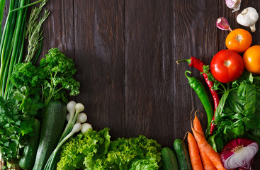Frame of fresh vegetables on wooden background with copy space