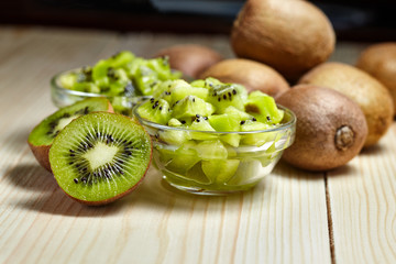 Healthy food. Tropical fruit. Whole and sliced kiwi. Kiwi fruit. Still life. Juicy kiwi on the wooden table