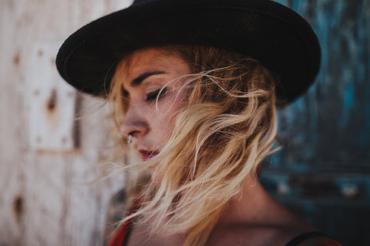 Fototapeta Romantic blonde girl in black hat with wind in hair