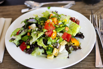 Lunch at the hotel. A fresh vegetable salad. Business lunch. The hotel is five stars. Main dishes. Salad on the table

