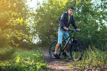 Naklejka premium Mountain biker rides a Bicycle in the morning
