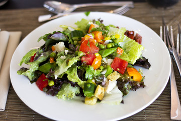 Lunch at the hotel. A fresh vegetable salad. Business lunch. The hotel is five stars. Main dishes. Salad on the table

