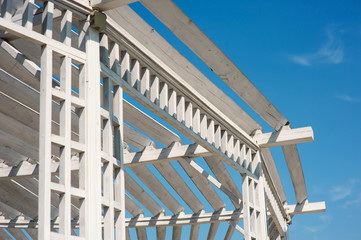 white gazebo in the park against blue sky