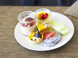 Dessert on a plate. Delicious sweet dessert. Refreshments. Souffle and cakes on a white plate
