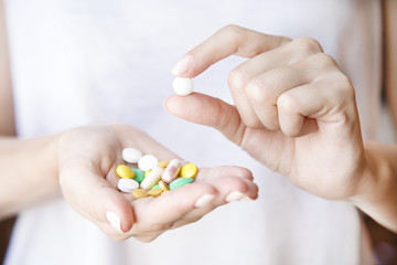 Pills in women's hands. a lot of different pills. Closeup.