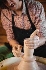 Fototapeta na wymiar Potter master creating new ceramic pot