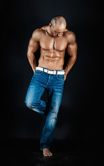 Fototapeta na wymiar very muscular handsome athletic man on black background