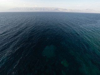 Blue sea and mountain in background