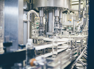 Robotic factory line for processing and bottling pure spring water into used gallons. Short depth of field and selective focus.