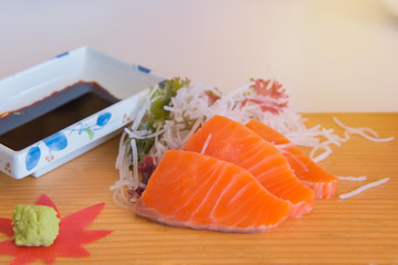 Salmon raw sashimi slices of smoked on wooden plate