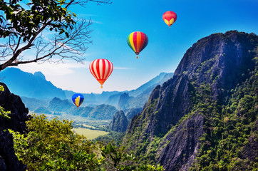 Colourful hot-air balloons flying over the mountain