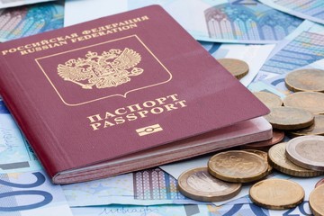 Some euro banknotes, coins and russian passport
