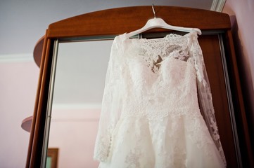 Dress bride on shoulders in closet