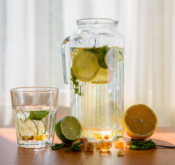 Pitcher of homemade lemonade with glass.
