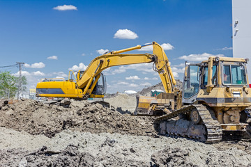 Heavy construction machinery is leveling building site