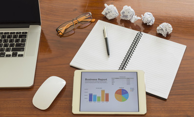 desk work  Office wood table with notepad, computer and flower.On top view.
