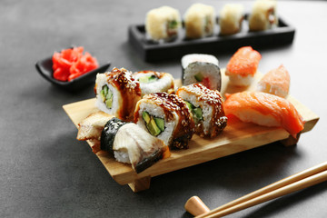 Delicious sushi set on wooden board