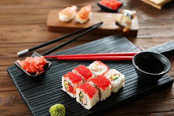 Delicious sushi set on wooden board