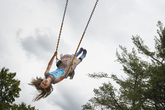 A girl on a rope swing, high in the air
