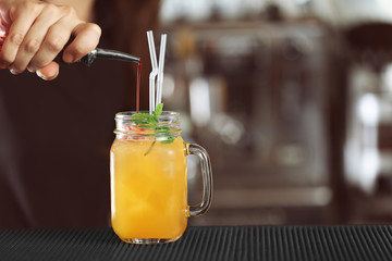 Woman hands making cocktail on bar counter