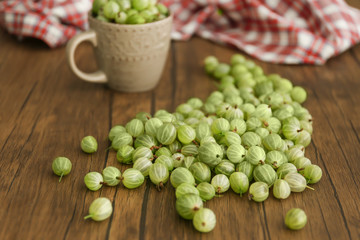 Gooseberries with cup on table