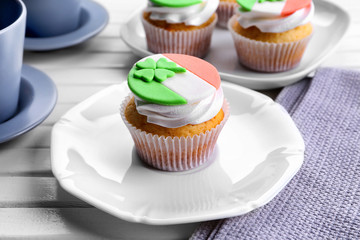 Tasty cupcakes with clover on plate. Saint Patrics Day concept