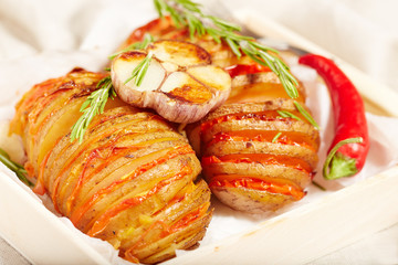 Potato roasted with tomatoes, served with rosemary, garlic and pepper, vegetarian dish