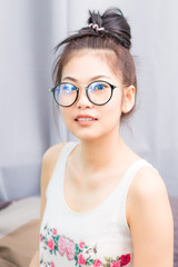 Happy asian young  student woman wear glasses at home