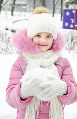 Fototapeta premium Portrait of adorable smiling little girl in winter day