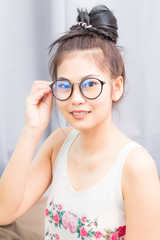 Happy casual young Asian nerd woman wearing eyeglasses