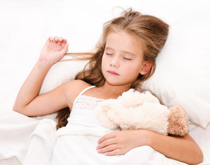 Adorable little girl sleeping with toy