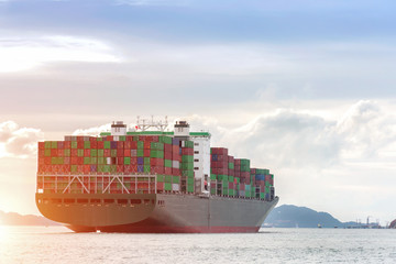 Container Cargo freight ship with working crane bridge in shipyard at dusk for Logistic Import...