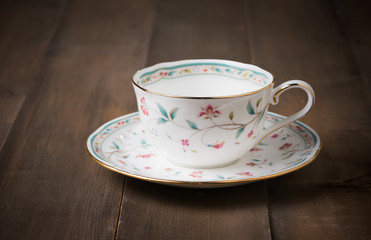 white cup of coffee on wood background