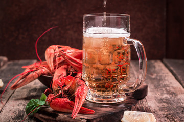 boiled crawfish and beer on a wooden background