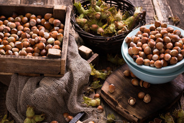 Hazelnuts on rustic wooden background