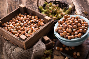 Hazelnuts on rustic wooden background