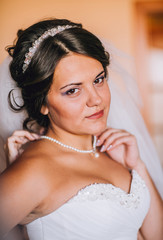 Happy buddies helps bride getting ready for her wedding day in the morning