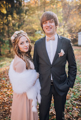 groomsman and bridesmaid in the park embracing.