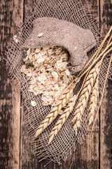 Fototapeta na wymiar oat flakes on wooden table.healthy food concept.